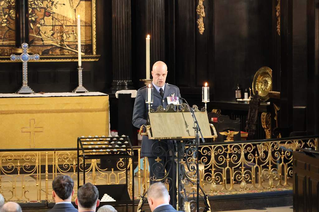 An attendee delivers a reading from a lecturn.